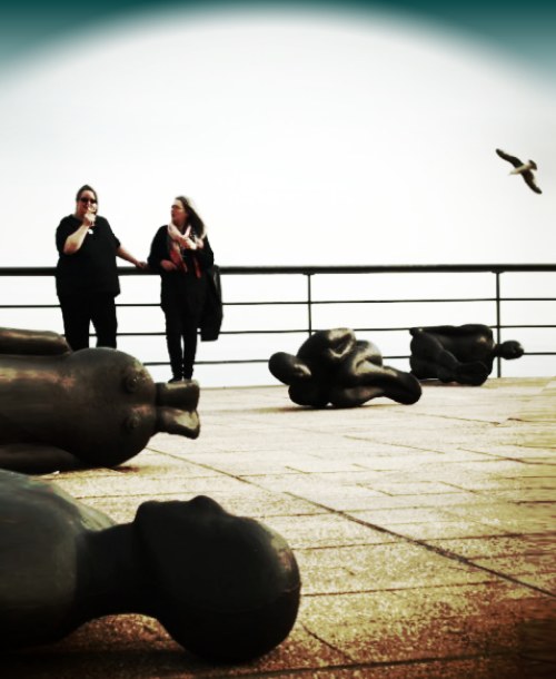Gormley inspired art image - people in black on the DeLaWarr pavillion roof in Bexhill