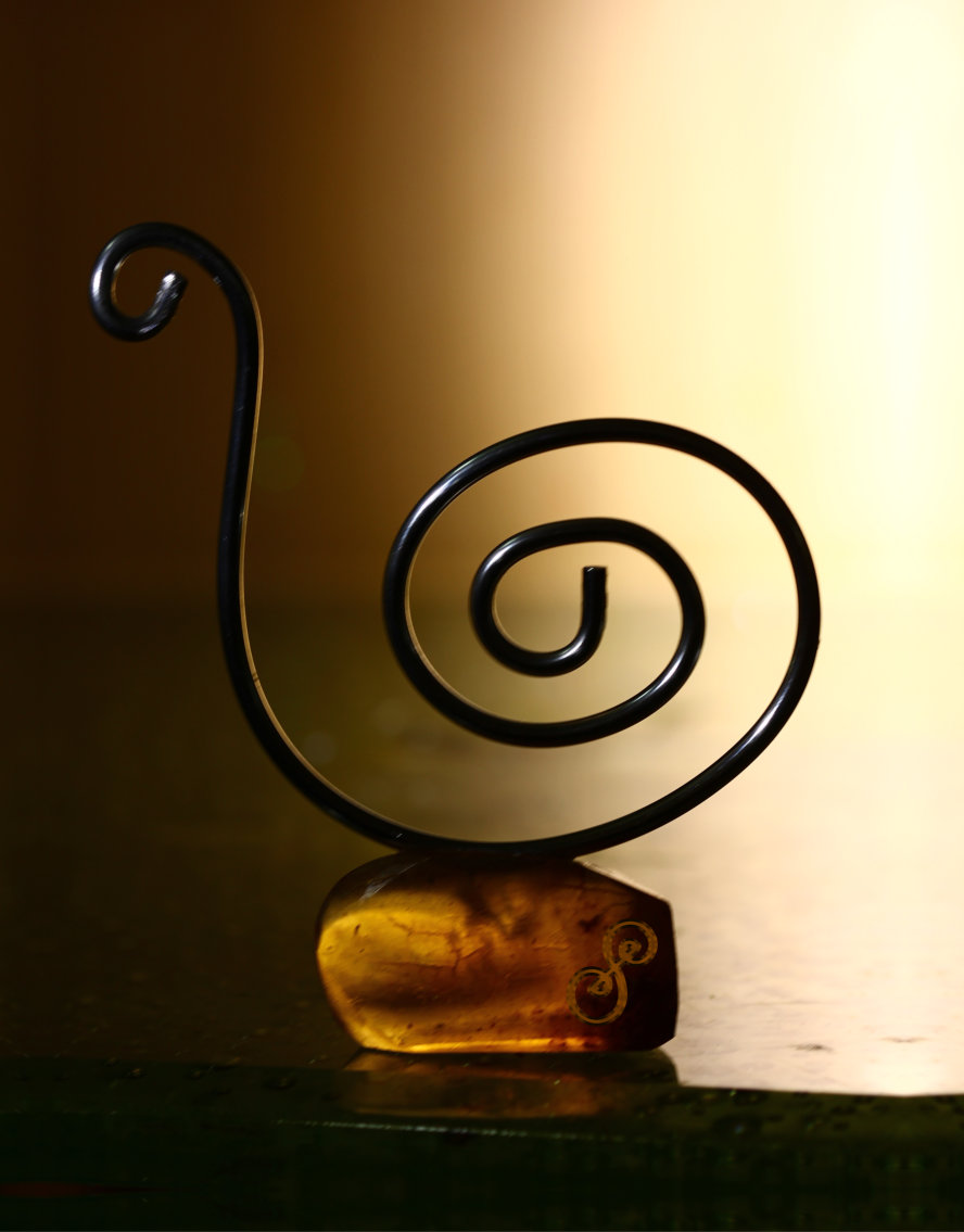 Snail sculpture aluminium mounted on amber